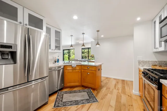 a kitchen with granite countertop a stove and a sink