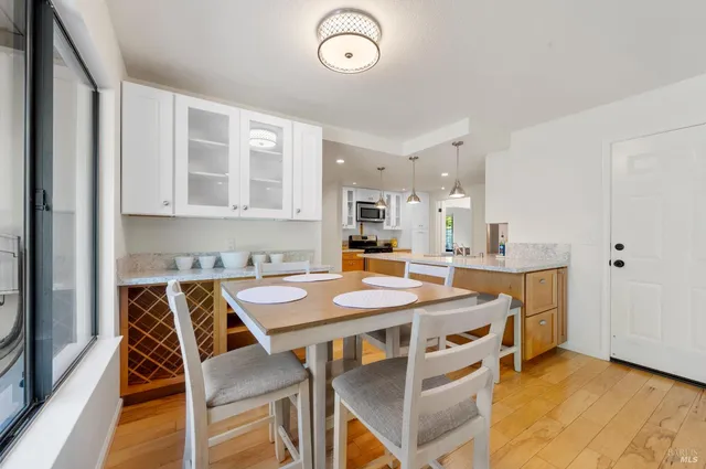 a bathroom with a granite countertop sink a toilet and a mirror