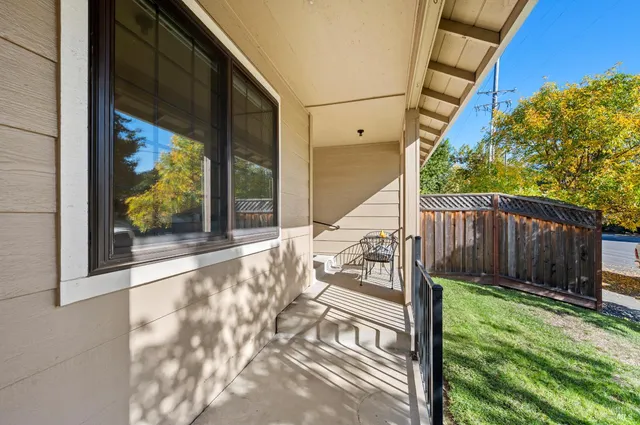 a view of balcony with two chairs and a potted plant