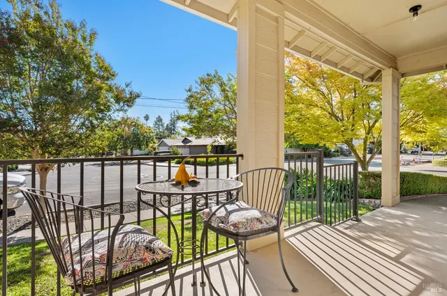a view of a hallway with wooden floor and windows