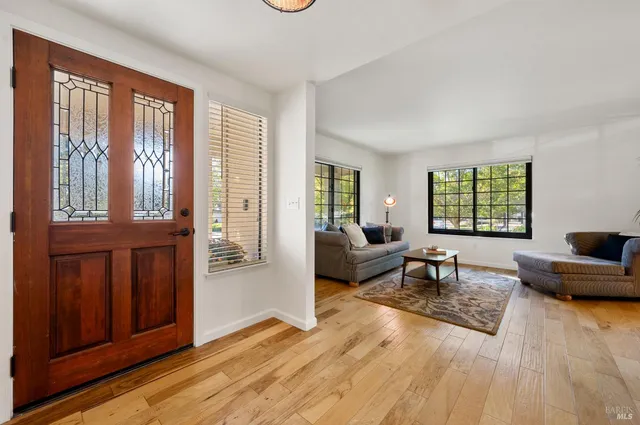 a living room with furniture rug and window