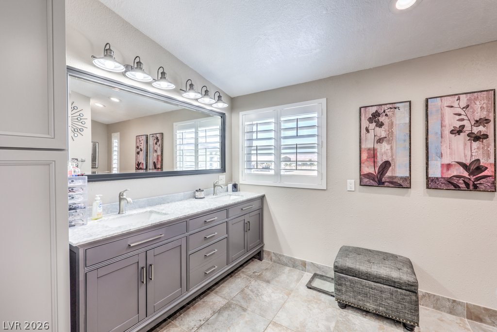 4375 Pinwheel Street Logandale, NV 89021 - Photo 23 of 52 Dual vanities with stone counters in the primary en-suite bathroom.