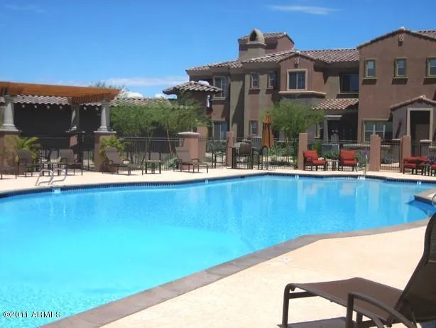 a backyard of a house with table and chairs