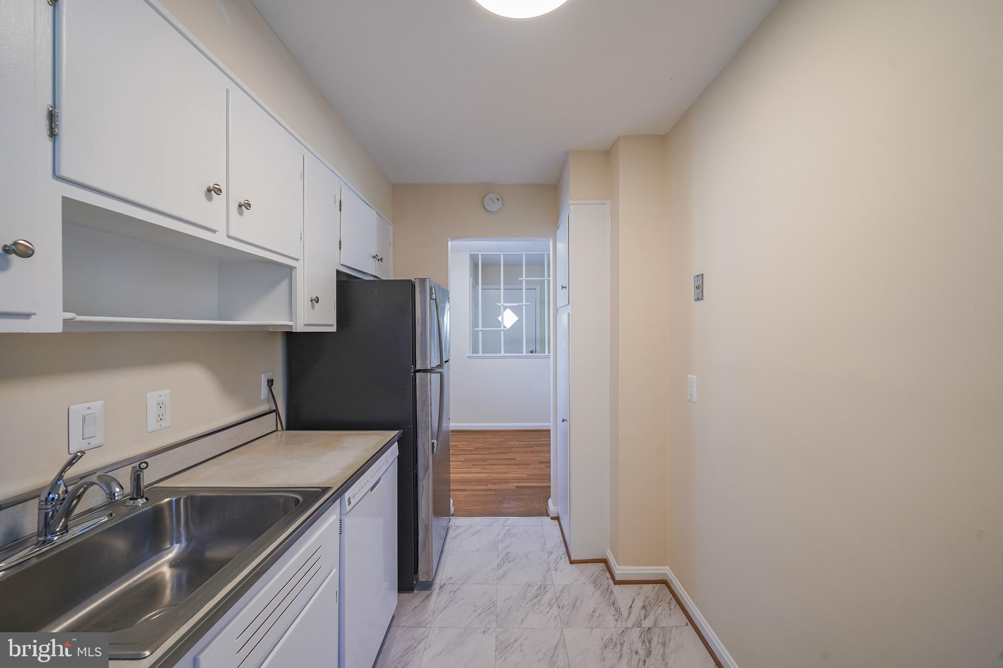 11500 Mapleview Drive Silver Spring, MD 20902 - Photo 12 of 32 a kitchen with a sink and refrigerator
