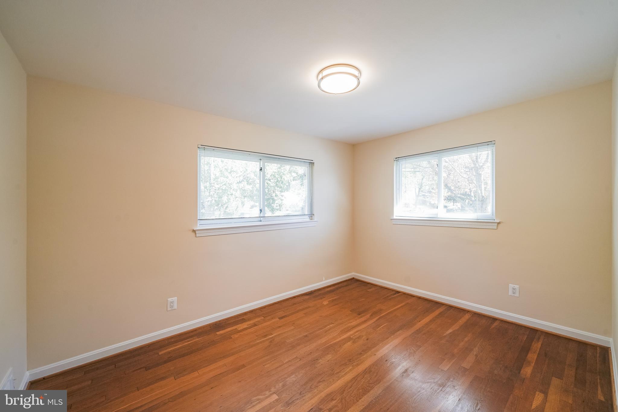 11500 Mapleview Drive Silver Spring, MD 20902 - Photo 16 of 32 a view of a room with wooden floor and window