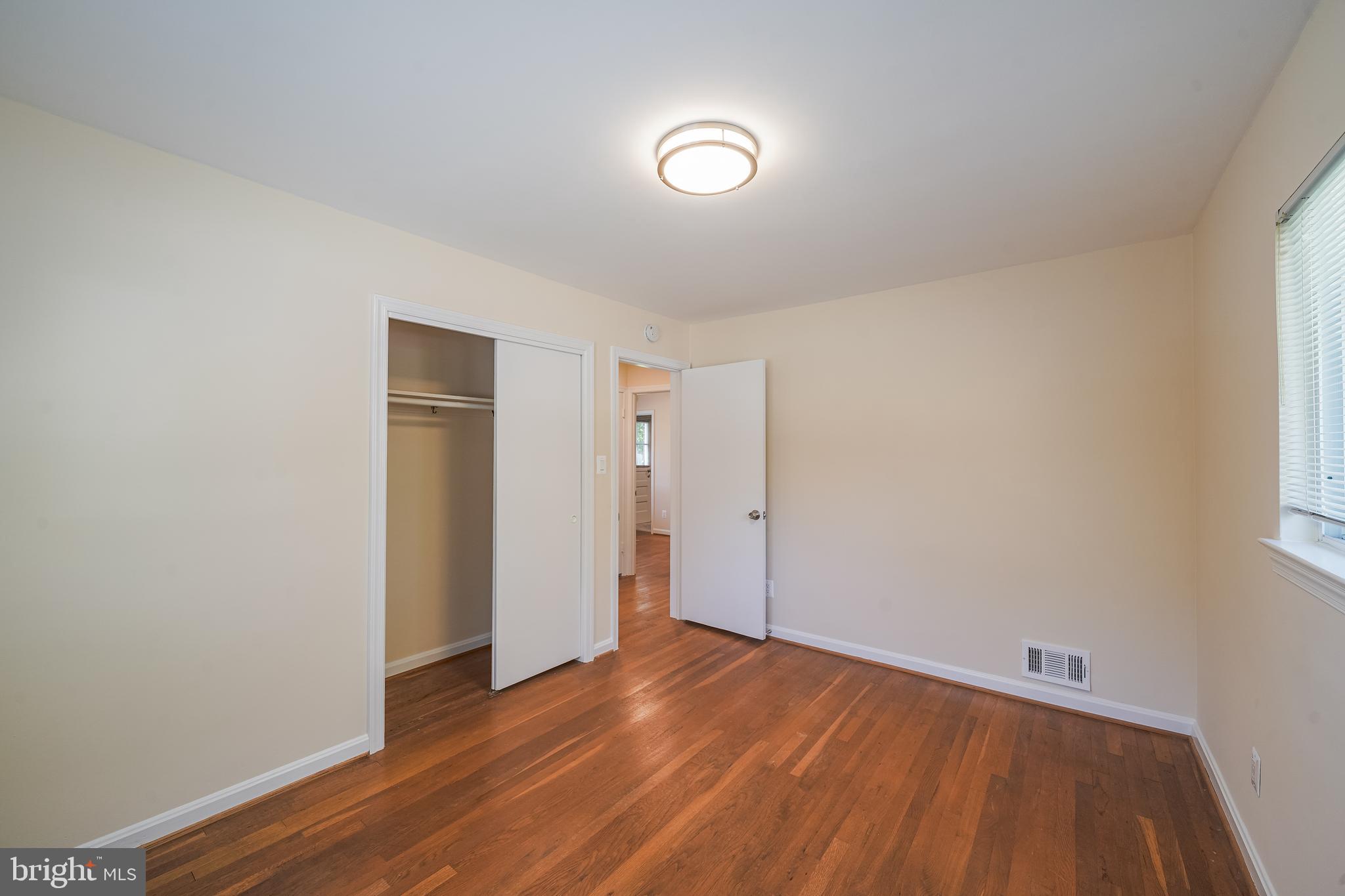 11500 Mapleview Drive Silver Spring, MD 20902 - Photo 17 of 32 a view of an empty room with wooden floor and a window