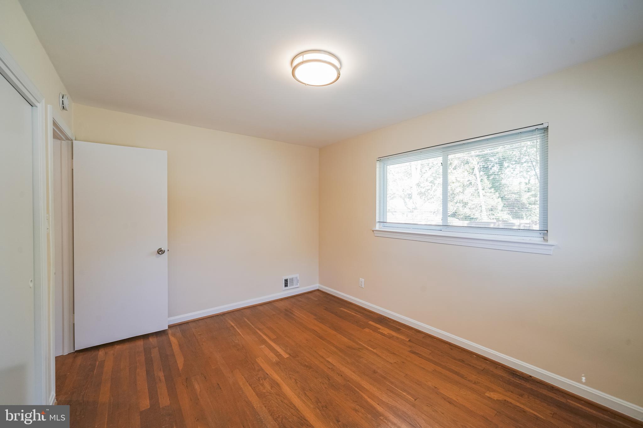 11500 Mapleview Drive Silver Spring, MD 20902 - Photo 18 of 32 a view of a room with wooden floor and windows in a room