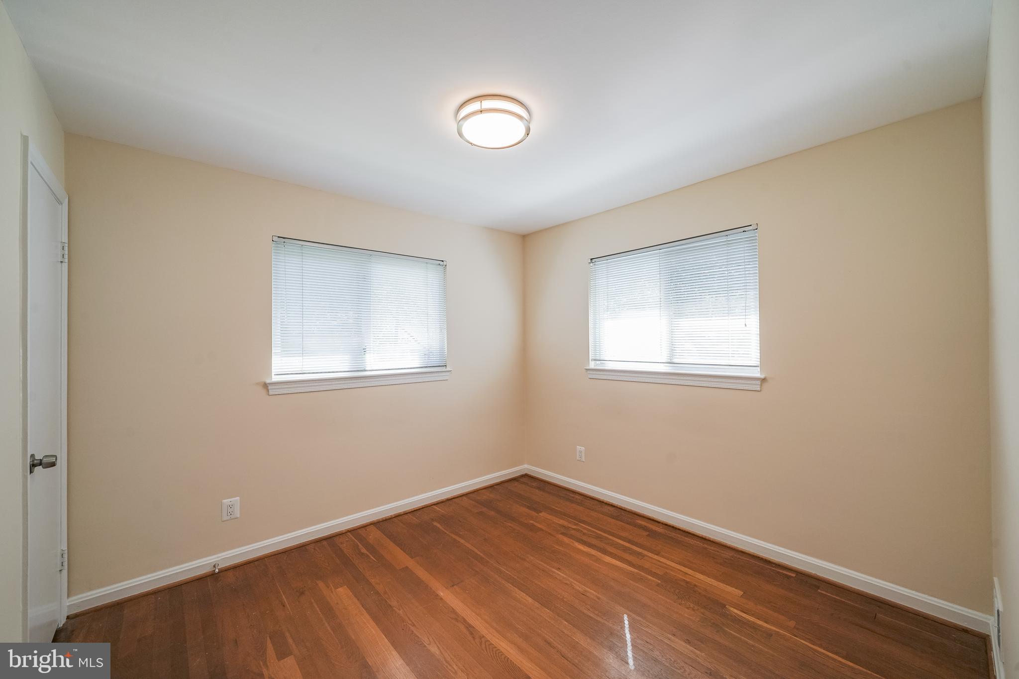 11500 Mapleview Drive Silver Spring, MD 20902 - Photo 19 of 32 a view of empty room with wooden floor and fan
