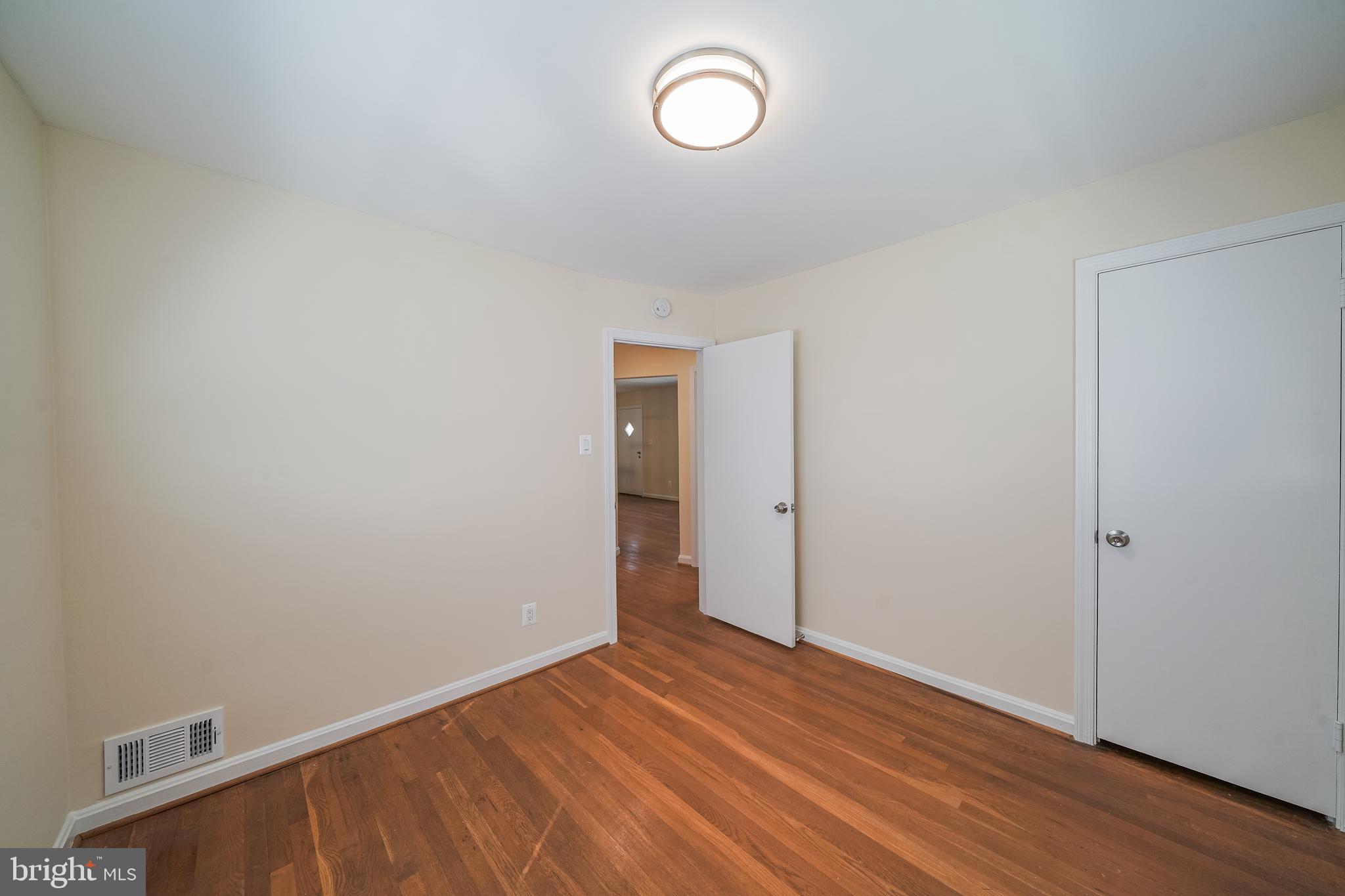 11500 Mapleview Drive Silver Spring, MD 20902 - Photo 20 of 32 a view of room with wooden floor and window