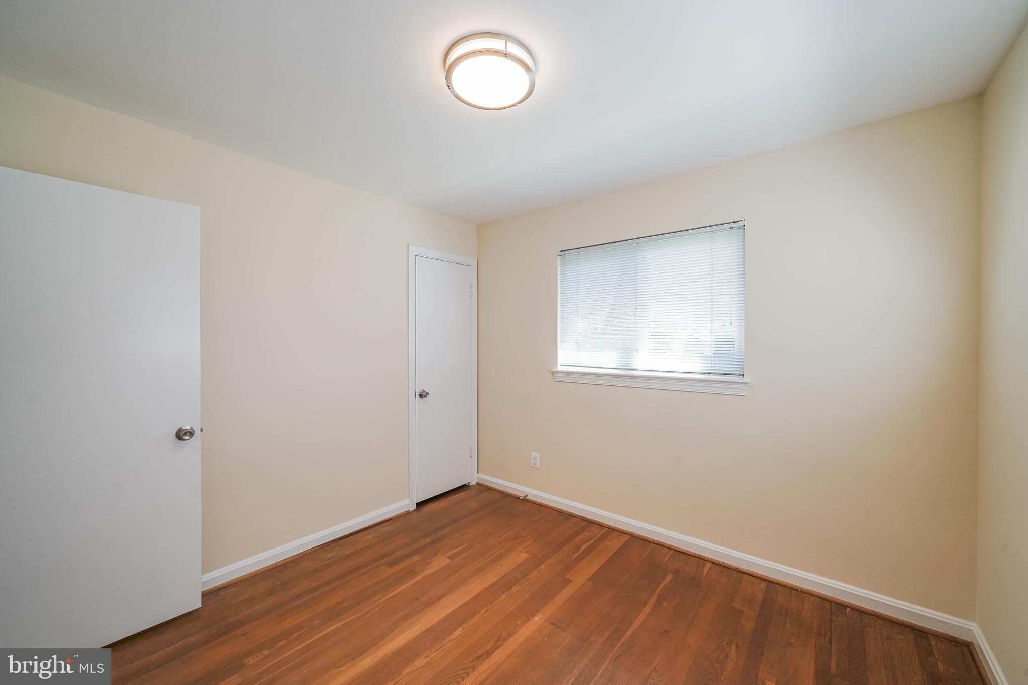 11500 Mapleview Drive Silver Spring, MD 20902 - Photo 21 of 32 an empty room with wooden floor and windows