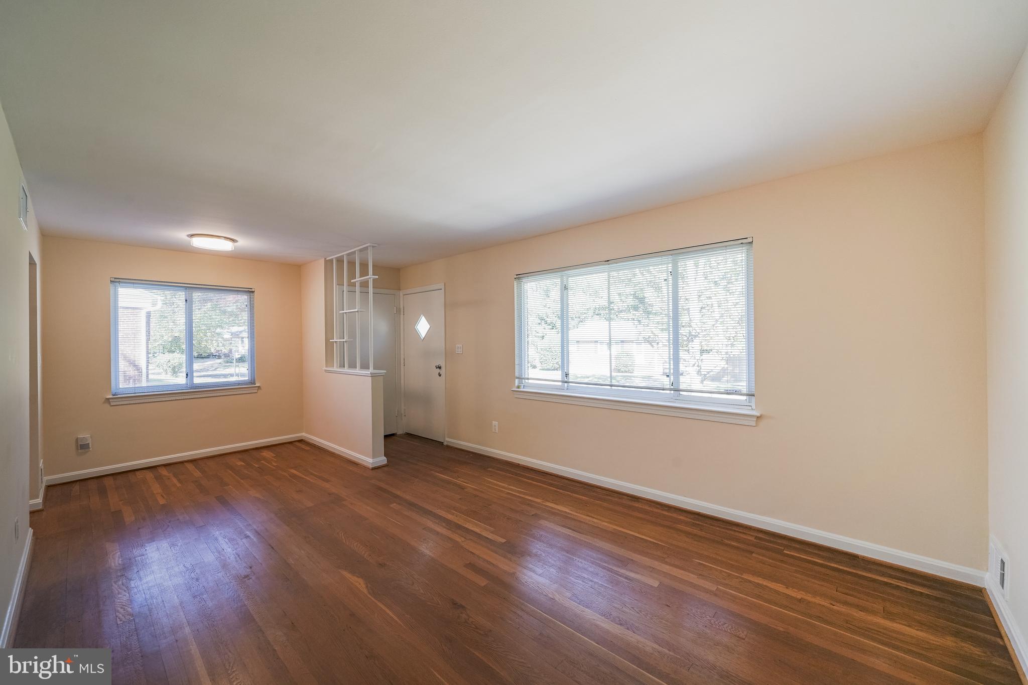 11500 Mapleview Drive Silver Spring, MD 20902 - Photo 8 of 32 an empty room with wooden floor and windows