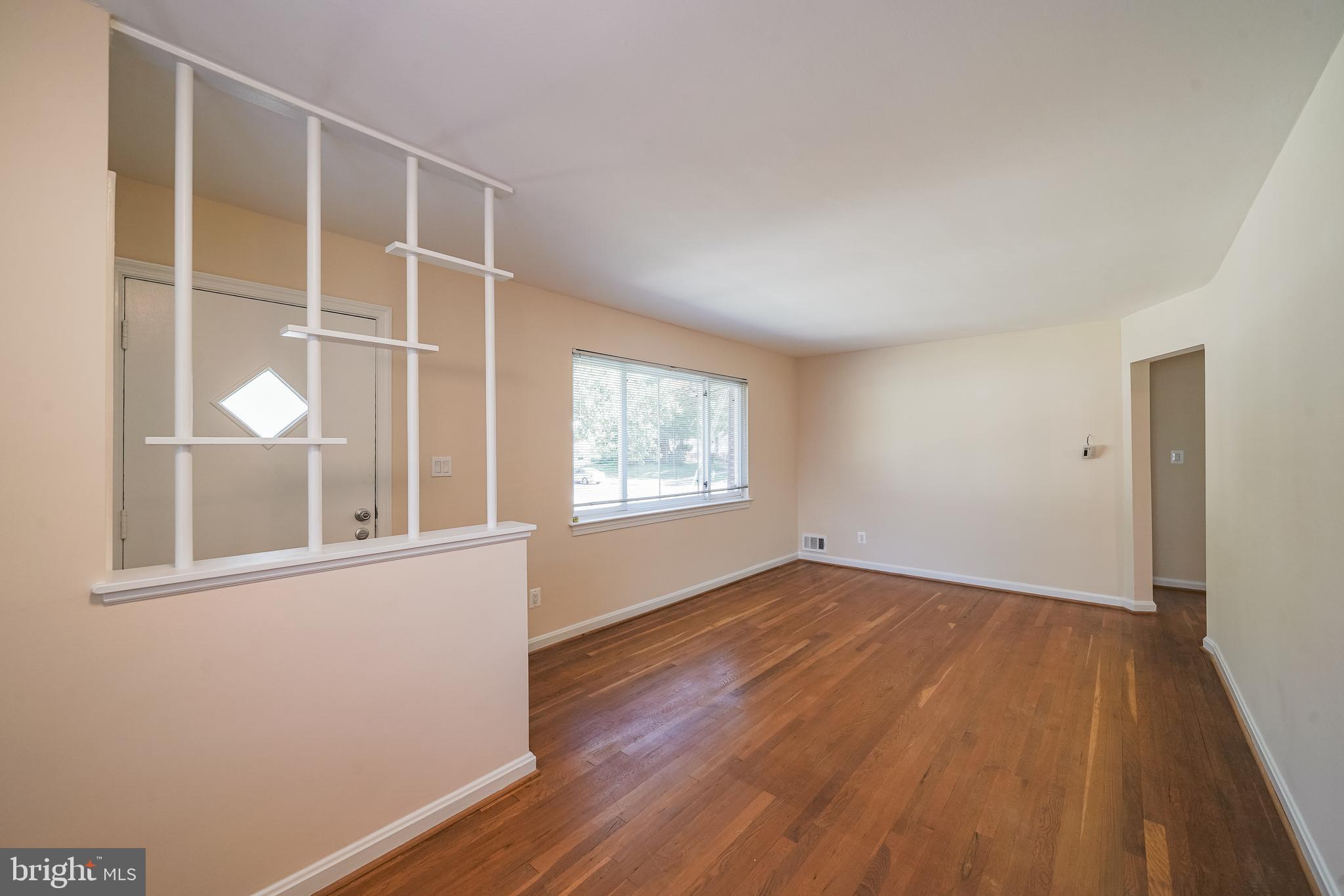 11500 Mapleview Drive Silver Spring, MD 20902 - Photo 9 of 32 an empty room with wooden floor and windows