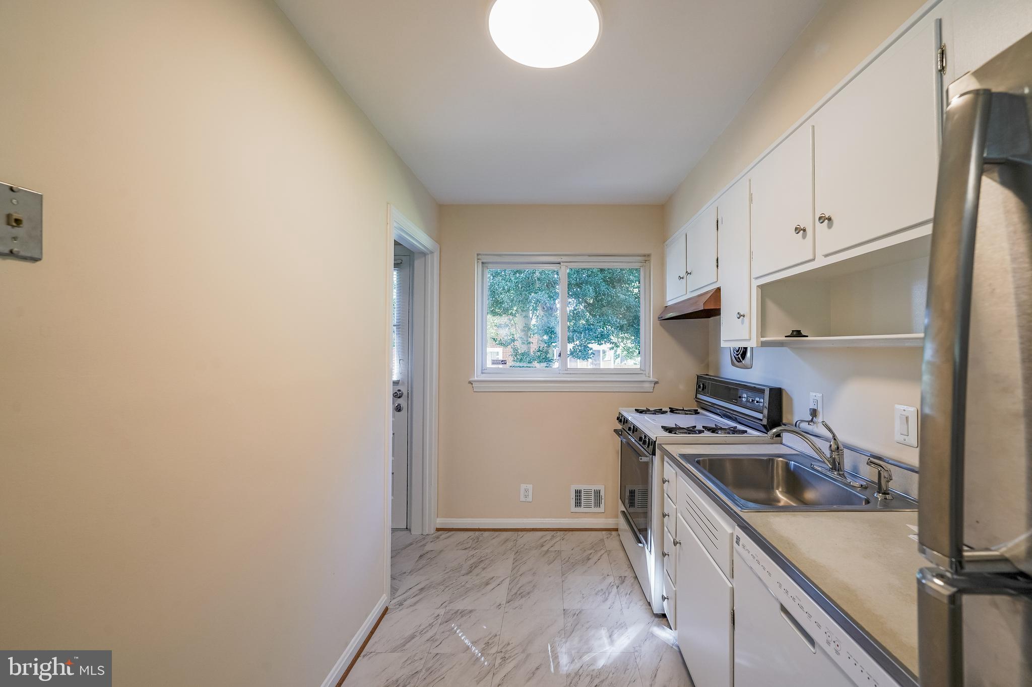 11500 Mapleview Drive Silver Spring, MD 20902 - Photo 10 of 32 a kitchen with a stove a sink and a refrigerator