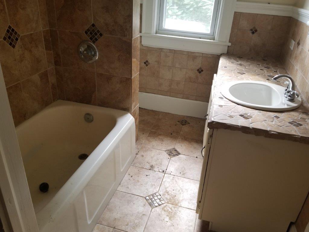 5913 Brethren Road Roanoke, VA 24014 - Photo 12 of 17 a bathroom with a granite countertop sink a toilet and bathtub