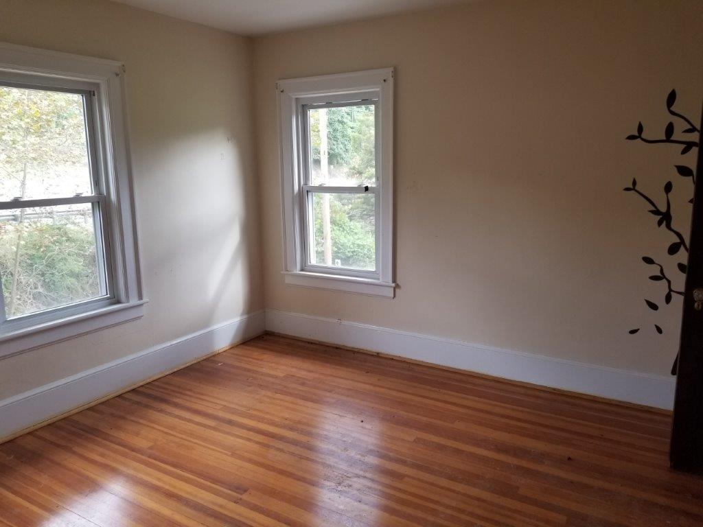 5913 Brethren Road Roanoke, VA 24014 - Photo 8 of 17 a view of an empty room with wooden floor and a window