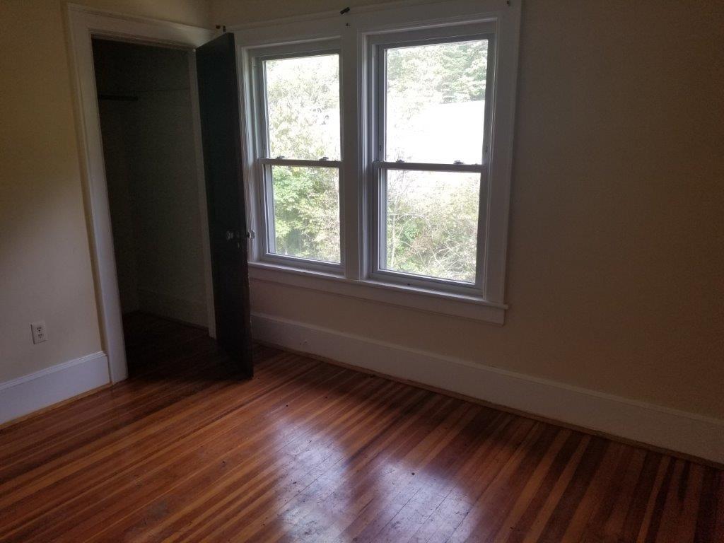 5913 Brethren Road Roanoke, VA 24014 - Photo 10 of 17 a view of an empty room with wooden floor and a window
