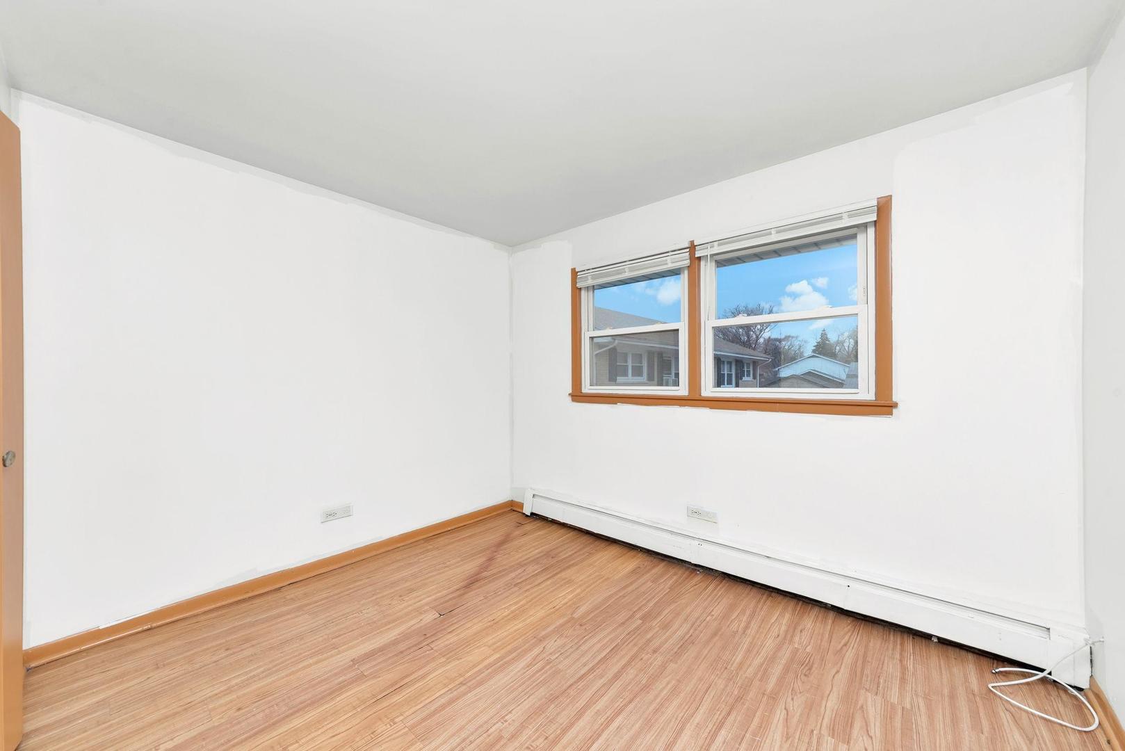 14526 Cottage Grove Avenue Dolton, IL 60419 - Photo 13 of 15 a view of empty room with wooden floor and fan