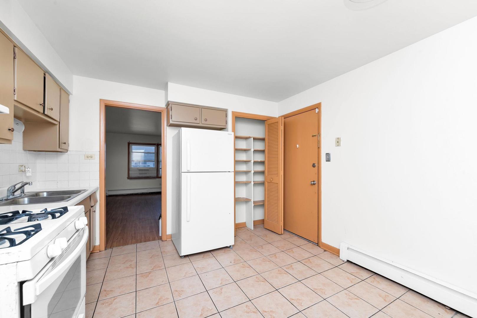14526 Cottage Grove Avenue Dolton, IL 60419 - Photo 7 of 15 a kitchen with a refrigerator and a stove