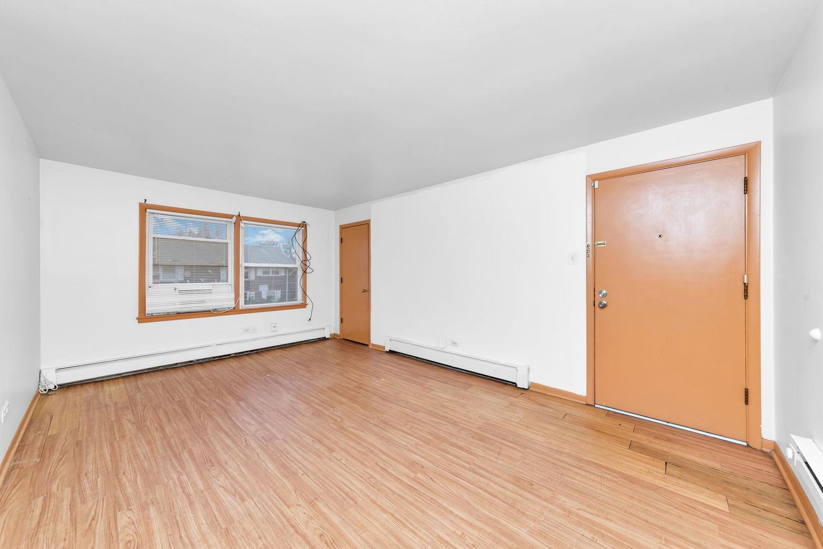 14526 Cottage Grove Avenue Dolton, IL 60419 - Photo 8 of 15 an empty room with wooden floor and windows