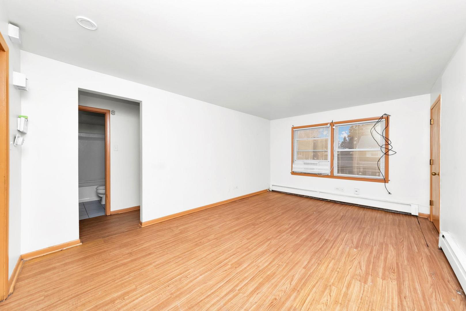14526 Cottage Grove Avenue Dolton, IL 60419 - Photo 9 of 15 an empty room with wooden floor and windows