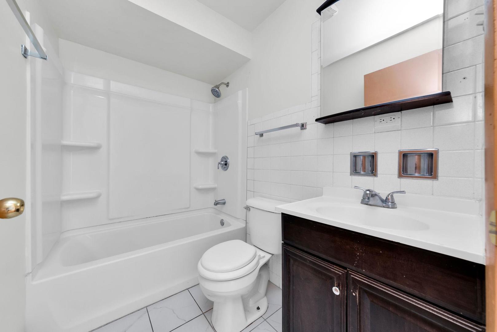 14526 Cottage Grove Avenue Dolton, IL 60419 - Photo 10 of 15 a bathroom with a sink a toilet and shower
