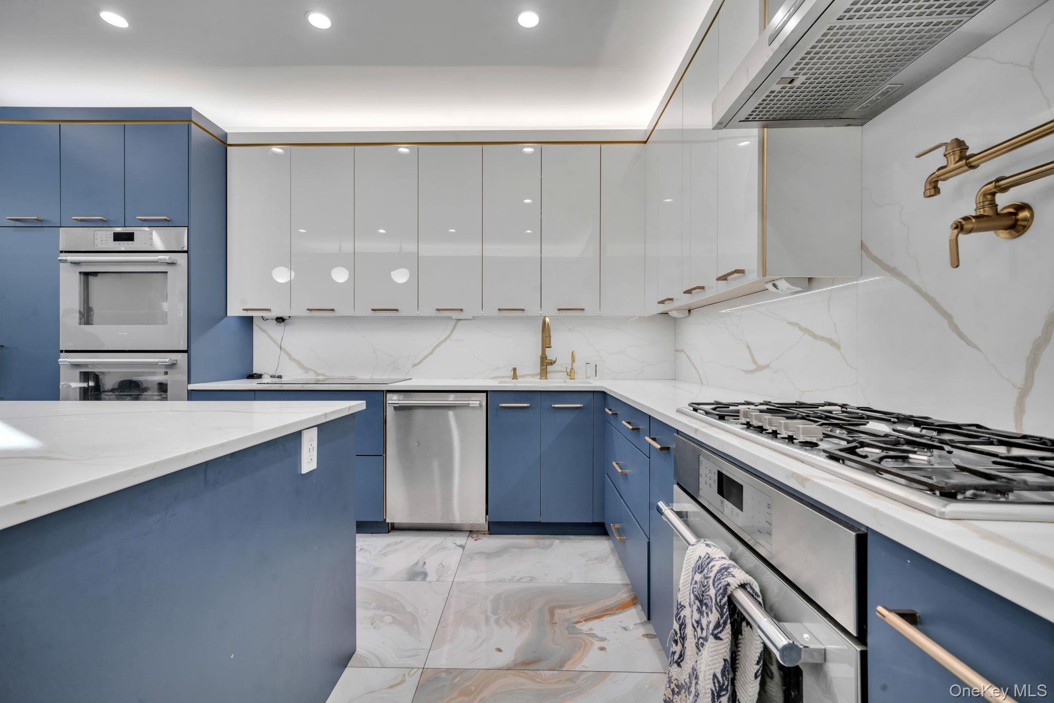 48 Garden Terrace Spring Valley, NY 10977 - Photo 11 of 20 a kitchen with stainless steel appliances granite countertop a sink stove and cabinets