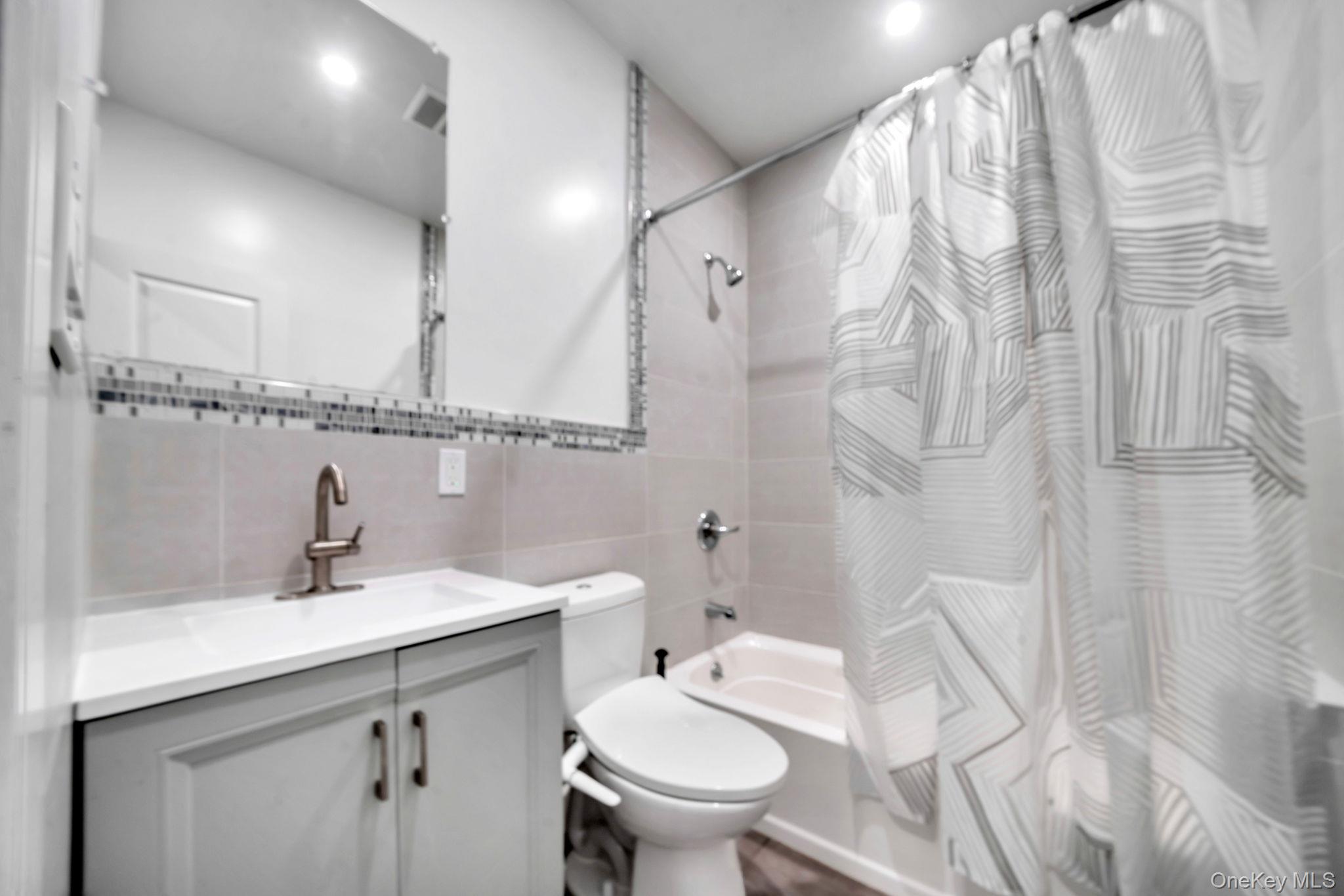 48 Garden Terrace Spring Valley, NY 10977 - Photo 14 of 20 a bathroom with a sink toilet and shower