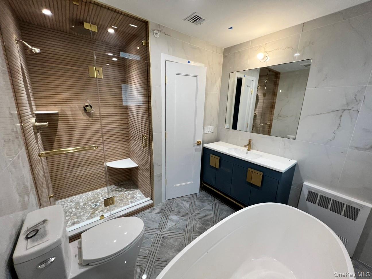 48 Garden Terrace Spring Valley, NY 10977 - Photo 19 of 20 a bathroom with a double vanity sink toilet and shower