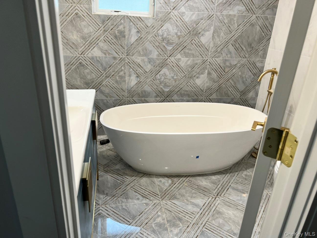 48 Garden Terrace Spring Valley, NY 10977 - Photo 20 of 20 a view of a bathtub in a bathroom