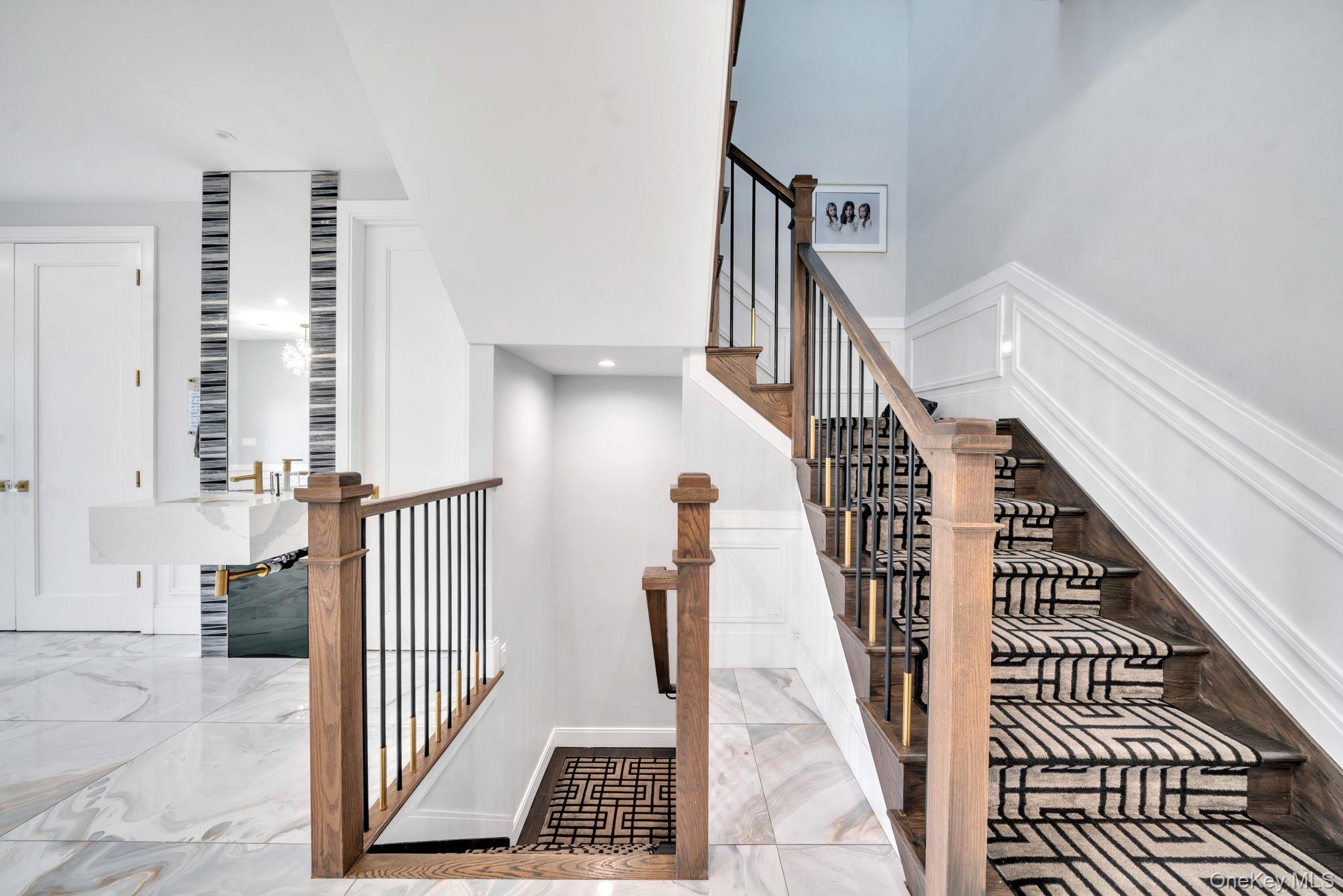 48 Garden Terrace Spring Valley, NY 10977 - Photo 5 of 20 a view of staircase with lots of frames on wall and a window