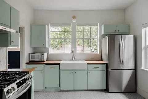 a kitchen with stainless steel appliances a refrigerator sink and stove