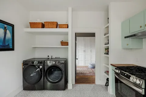 a utility room with sink dryer and washer