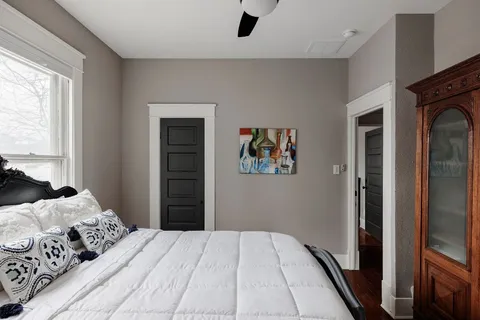 a bedroom with a large bed and a window