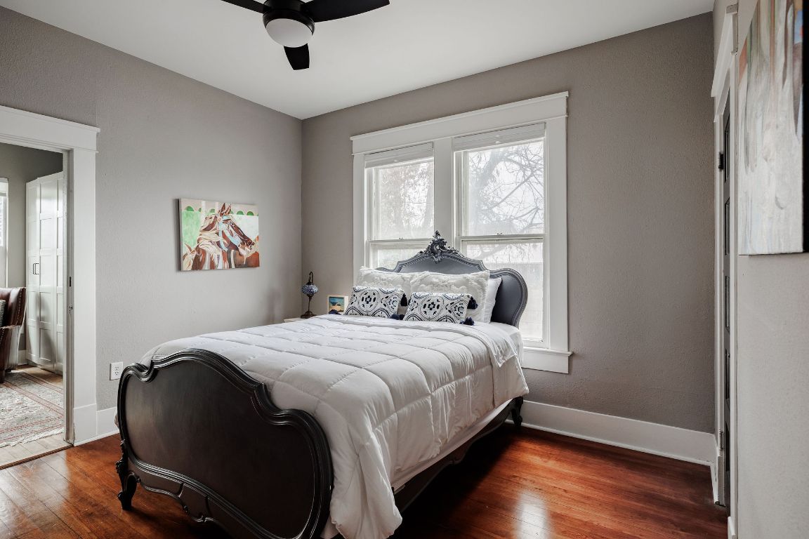 1907 Tillery Street Austin, TX 78723 - Photo 17 of 28 a bedroom with a bed and wooden floor