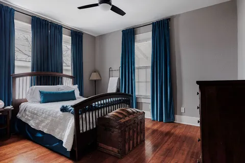 a bedroom with furniture and windows