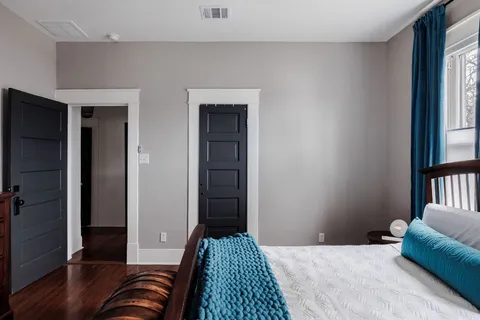a bedroom with a bed and a window