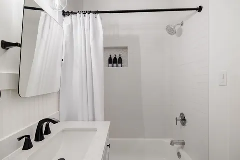 a bathroom with a shower and a sink