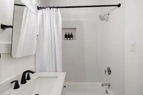a bathroom with a shower and a sink
