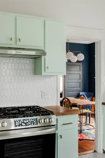 a stove top oven sitting inside of a kitchen