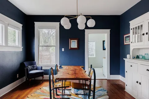 a dining room with furniture and window