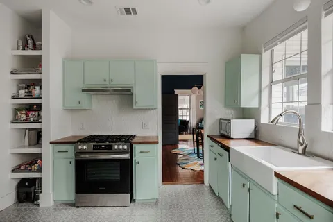 a kitchen with stainless steel appliances granite countertop a stove and a sink