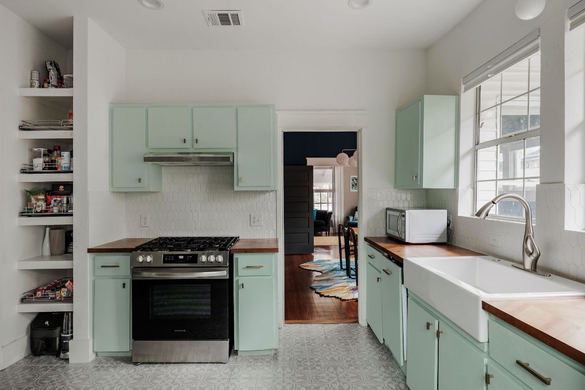 1907 Tillery Street Austin, TX 78723 - Photo 10 of 28 a kitchen with stainless steel appliances granite countertop a stove and a sink