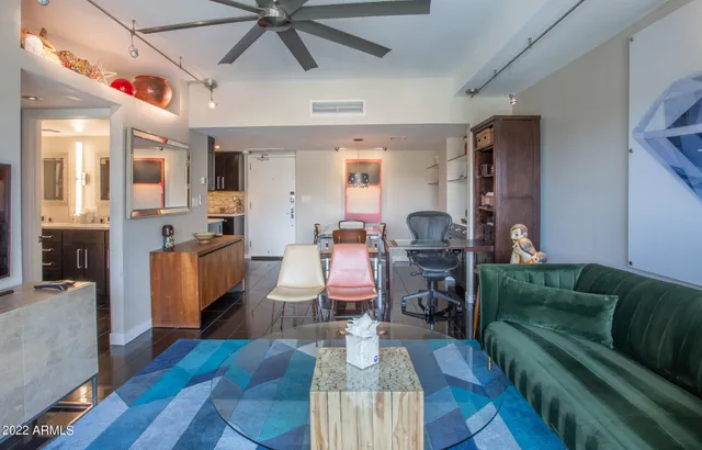 a living room with furniture and a floor to ceiling window