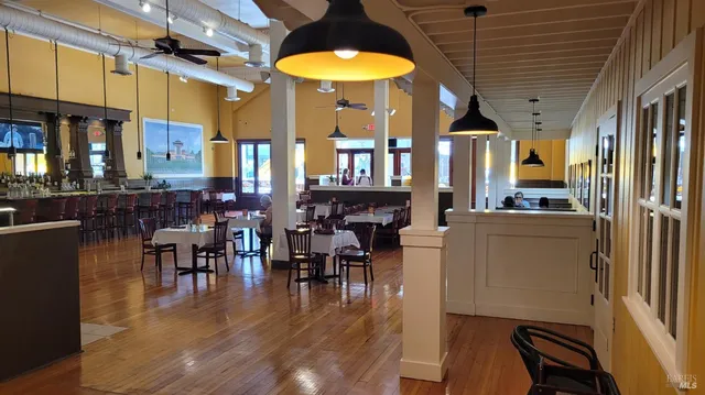 a view of a dining room with furniture and chandelier