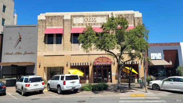 a view of a living room with furniture and a large window