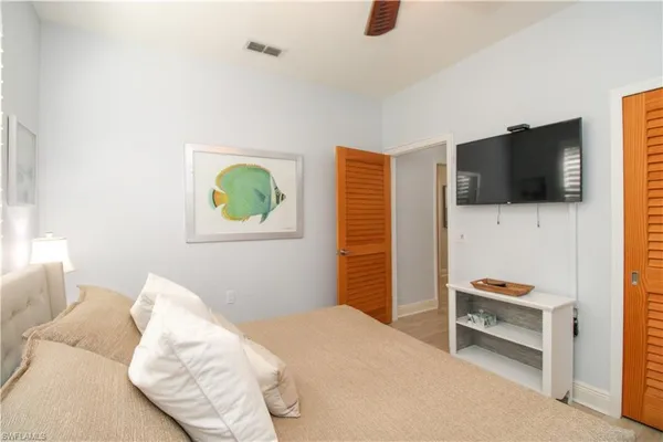 a bedroom with a bed and a flat screen tv