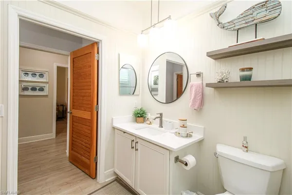a bathroom with a double vanity sink toilet and a mirror