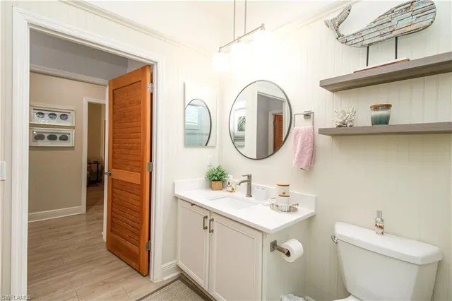 a bathroom with a double vanity sink toilet and a mirror