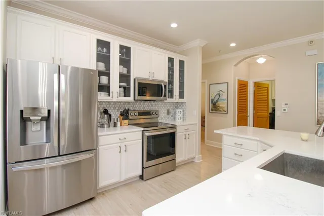 a kitchen with stainless steel appliances a refrigerator sink and cabinets