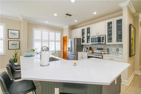 a kitchen with sink and refrigerator